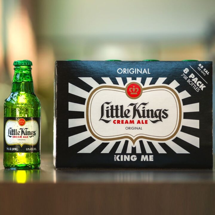 Little Kings beer bottle sitting next to an 8 pack of Little Kings Beer.